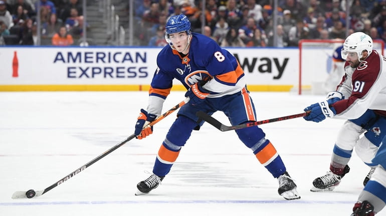 New York Islanders defenseman Noah Dobson skates with the puck...