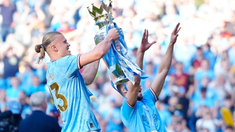Manchester City's Erling Haaland, left, celebrates Premier League title after...