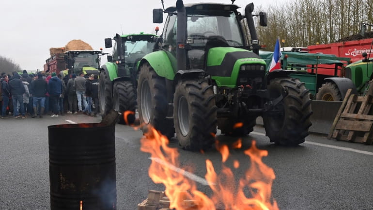 Farmers block a highway during a demonstration Tuesday, Jan. 23,...
