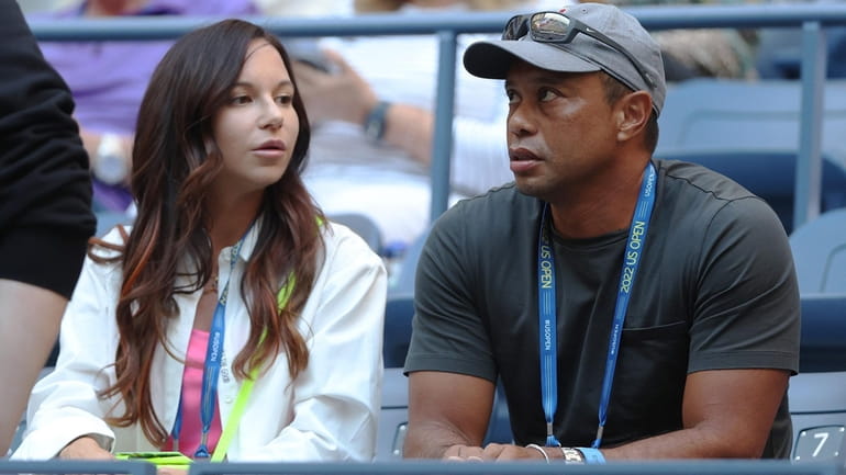 Erica Herman and Tiger Woods look on prior to the...
