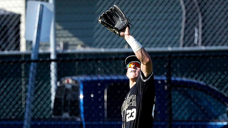 Commack's centerfielder Tim McHugh (23) makes the catch for the...