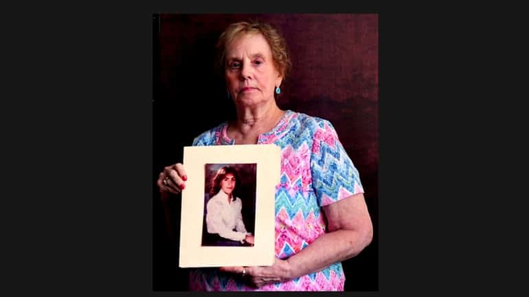 Barbara Goff holds a photo of her daughter Jennifer, who was...