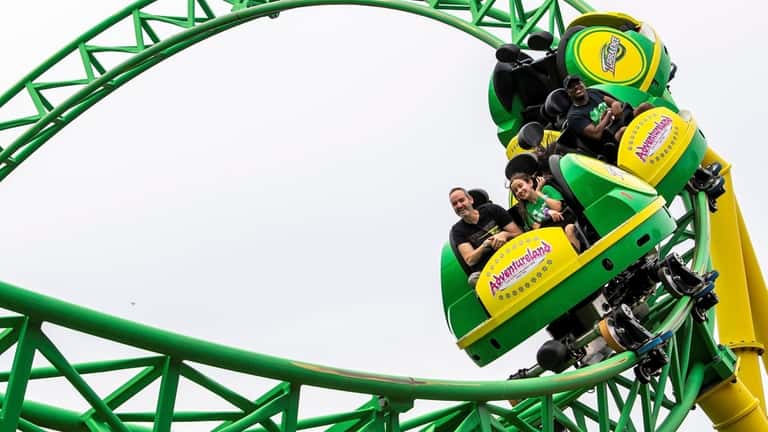 People enjoy amusement park rides at Adventureland on June 21, 2022,...