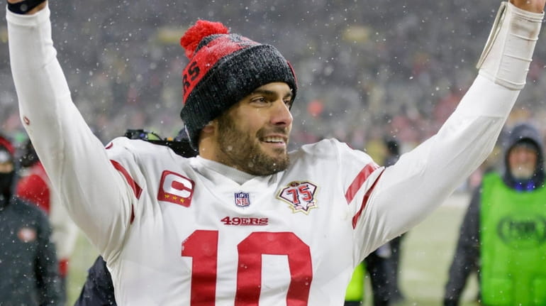 The 49ers' Jimmy Garoppolo celebrates after an NFC divisional playoff game...