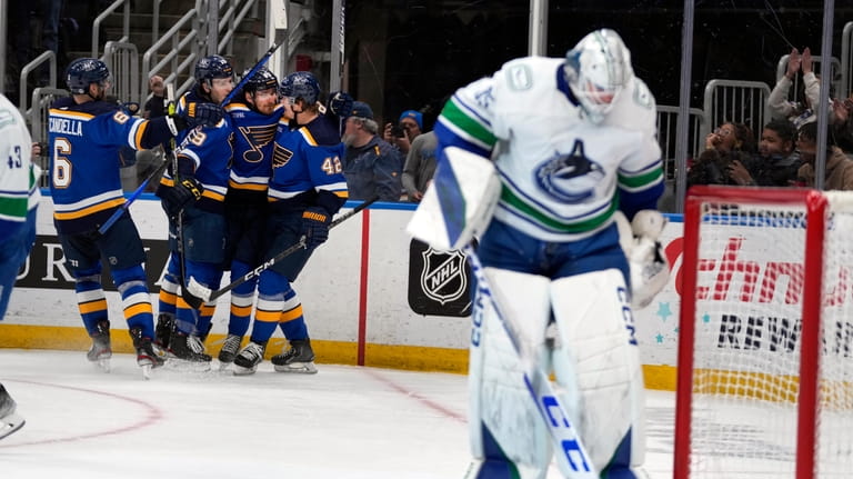 St. Louis Blues' Pavel Buchnevich (89) is congratulated by teammates...
