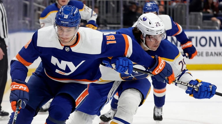 Pierre Engvall of the Islanders skates past Owen Power of the Sabres...