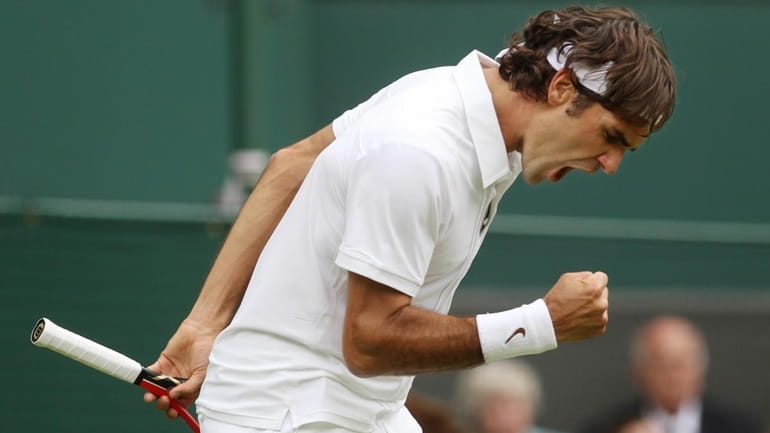 Switzerland's Roger Federer yells after winning the third set against...