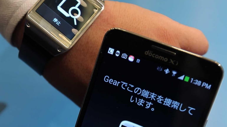 The Galaxy Gear watch, left, and Galaxy Note 3, manufactured...