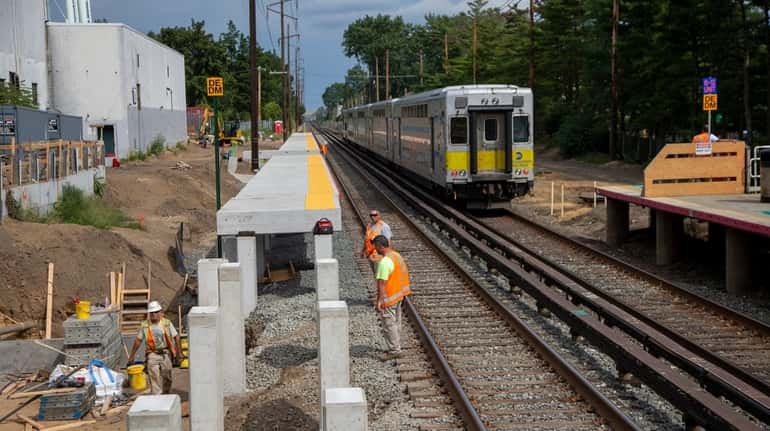 A construction crew works on the Third Track project on Sept....
