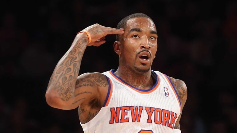 J.R. Smith signals after scoring a 3-pointer during a game...