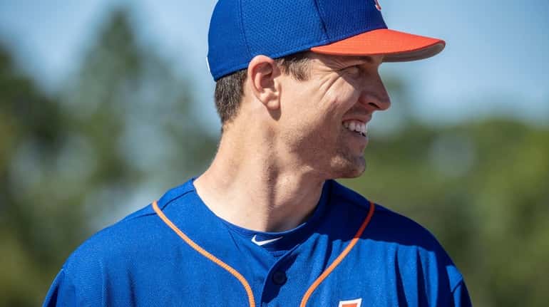 Mets pitcher Jacob deGrom looks on during a spring training...