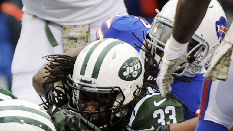 Chris Ivory scores a touchdown during the second half of...