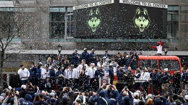 Confetti falls on the UConn men's basketball team during a...