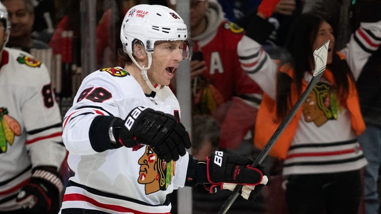 Chicago right wing Patrick Kane celebrates a hat trick during the...