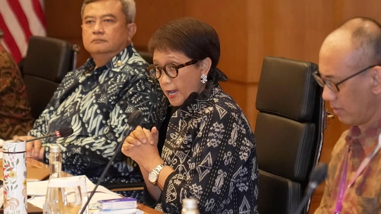 Indonesian Foreign Minister Retno Marsudi, center, speaks to U.S. Secretary...