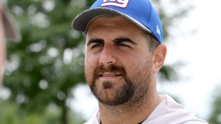Giants lineman John Greco talks to a reporter during training camp...