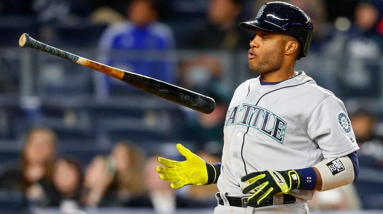 Robinson Cano  of the Seattle Mariners flips his bat after...