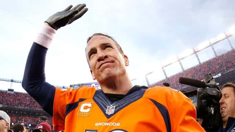 Peyton Manning of the Denver Broncos celebrates after defeating the...