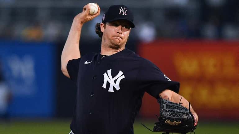 Gerrit Cole of the Yankees delivers a pitch in the...