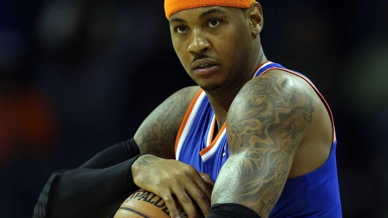 Knicks star Carmelo Anthony holds the ball before a game...