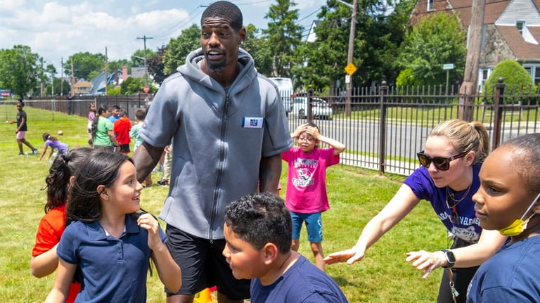 Students take part in field day with Giants linebacker Cam...