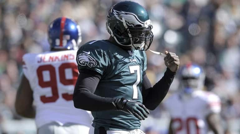 Philadelphia Eagles quarterback Michael Vick reacts after being sacked during...