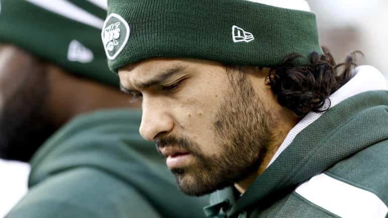 Mark Sanchez walks on the sidelines during a game against...
