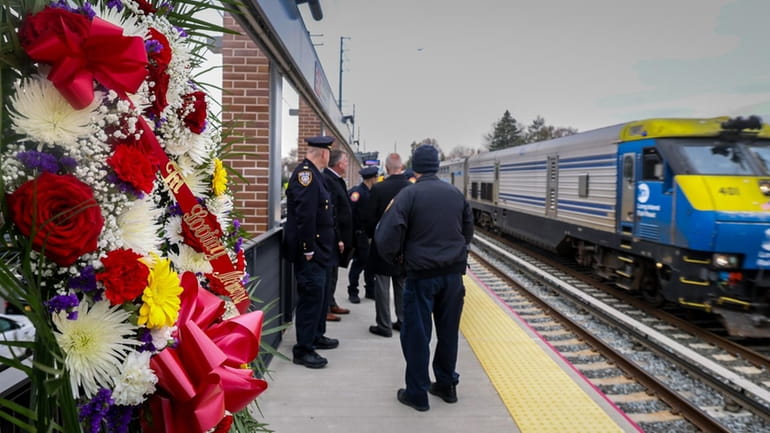 A LIRR train passes a wreath marking 30 years since the...
