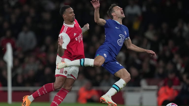 Chelsea's Cesar Azpilicueta, right, is challenged by Arsenal's Gabriel during...