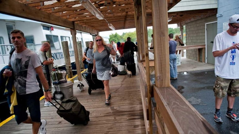 Residents from Fire Island Pines walk off the last evacuation...