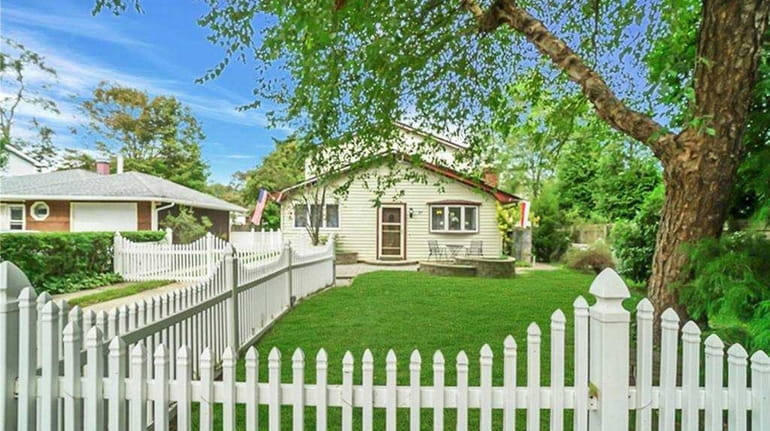 The fully fenced quarter-acre yard has a 20-by-10-foot patio with a retractable...