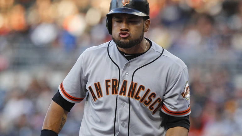 San Francisco Giants outfielder Melky Cabrera reacts after striking out...
