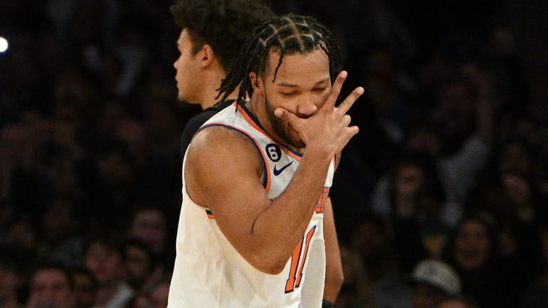 Knicks guard Jalen Brunson reacts after scoring a three-point basket...