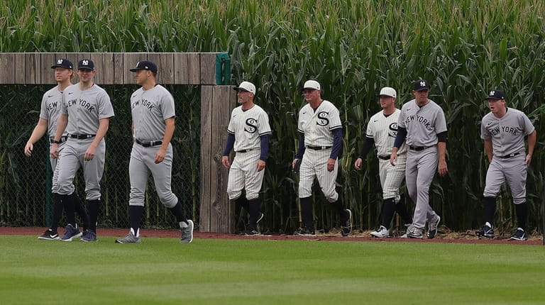 Players from the Yankees and White Sox emerge from the...