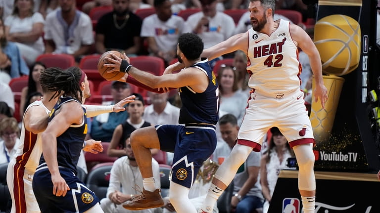 Miami Heat forward Kevin Love (42) defends Denver Nuggets guard...