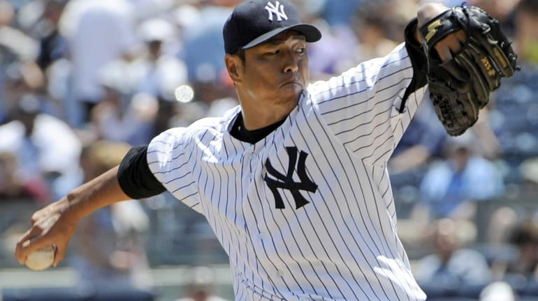 New York Yankees starter Hiroki Kuroda, of Japan, delivers a...