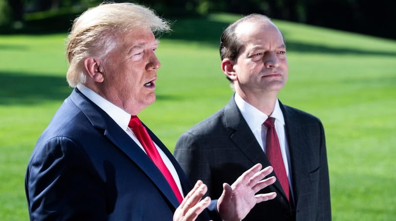 President Donald Trump speaks to reporters with Labor Secretary Alex Acosta on the...
