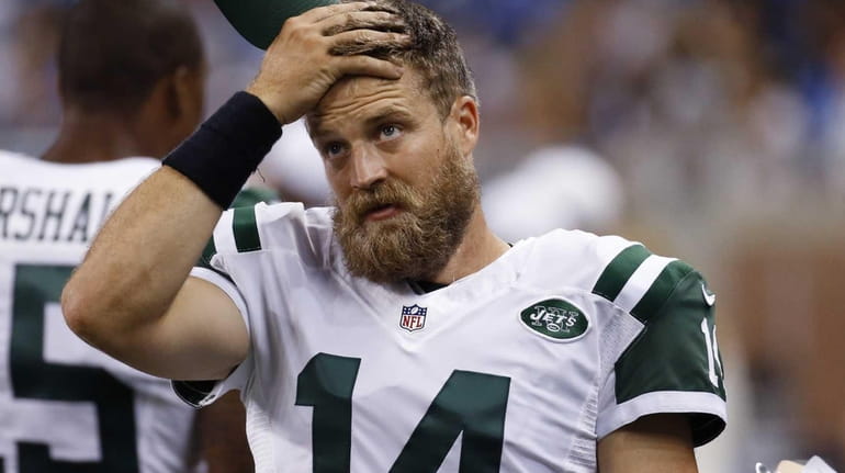 New York Jets quarterback Ryan Fitzpatrick wipes his forehead during...