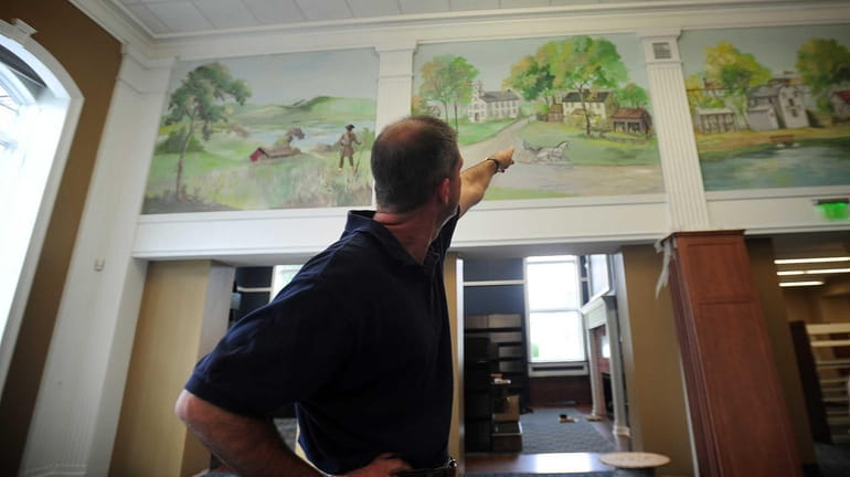 Robert Lusak, director of the Smithtown Special Library District, shows...