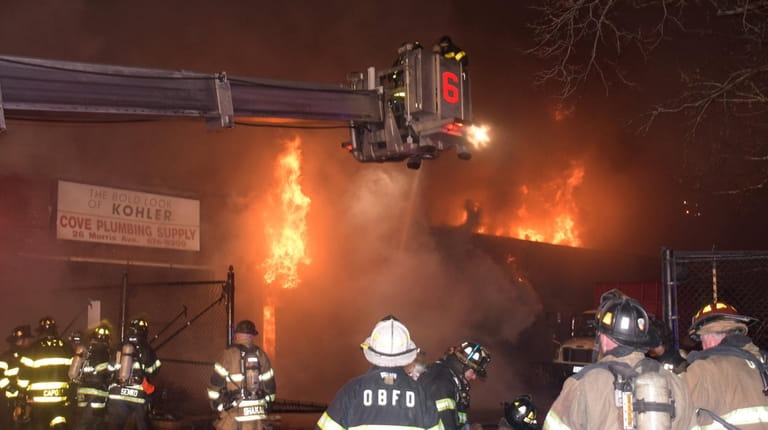 Firefighters at the warehouse fire in Glen Cove on Monday...