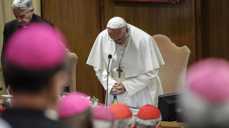Pope Francis (C) and Italian priest Federico Lombardi pray on...