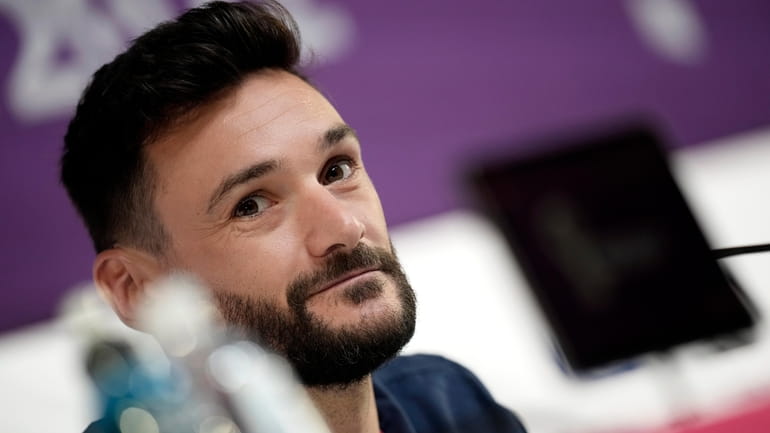 France's goalkeeper Hugo Lloris answers a reporter during a press...