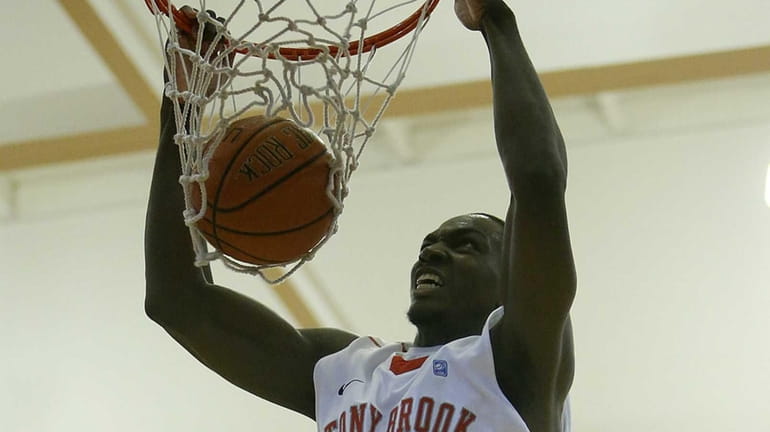 Stony Brook's Jameel Warney dunks off a pass from Dave...