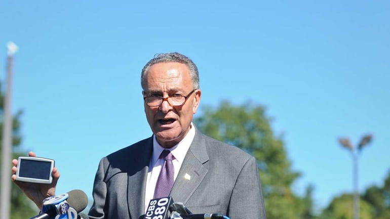 Senator Charles Schumer speaks, with a GPS in hand, about...