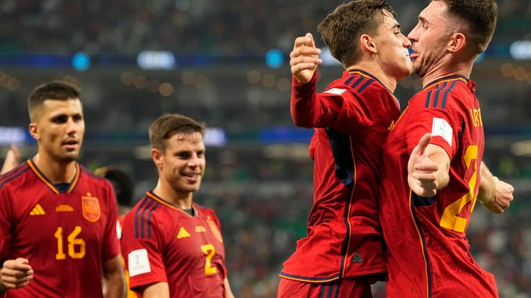 Spain's Gavi, second right, celebrates with Spain's Aymeric Laporte after...