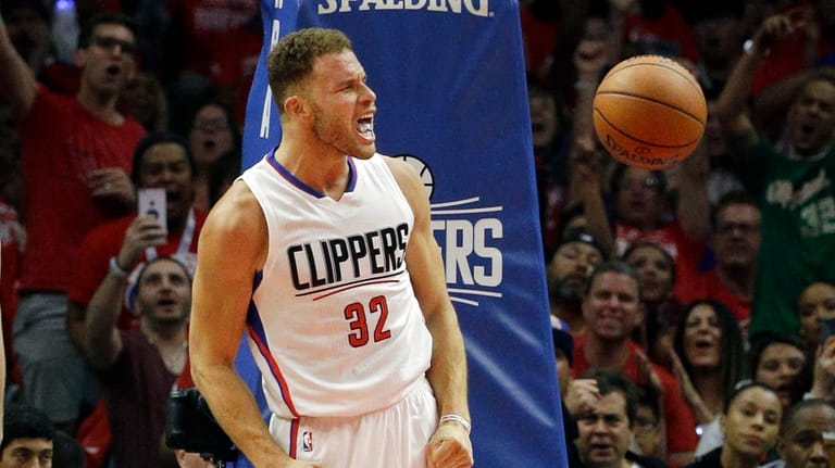 Los Angeles Clippers' Blake Griffin, right, reacts after making a...