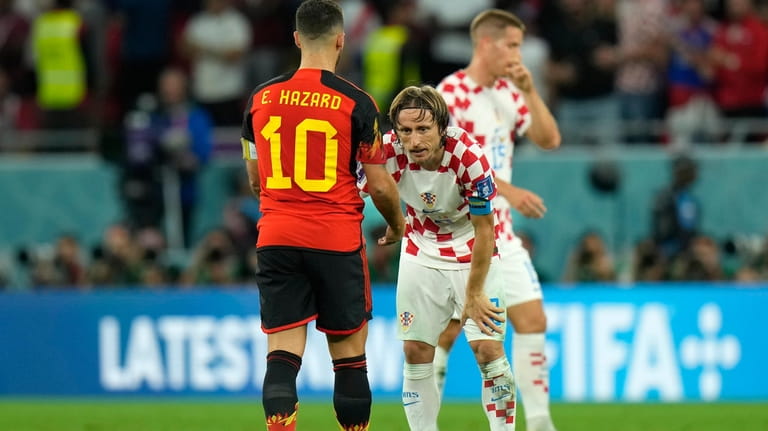 Belgium's Eden Hazard, left, and Croatia's Luka Modric shakeshands at...