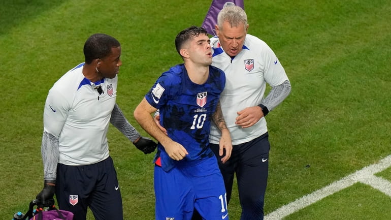 Christian Pulisic of the United States is helped by team...