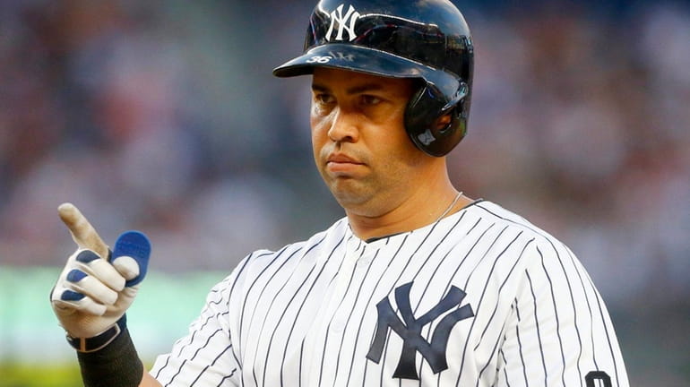 Carlos Beltran #36 of the New York Yankees reacts after...