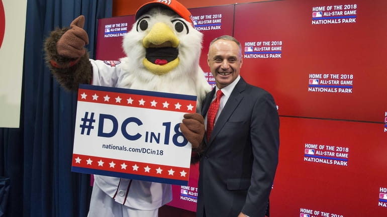 MLB commissioner Rob Manfred, right, stands with Washington Nationals mascot...